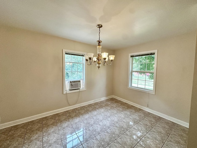 39 Leonard St, Elgin, IL 60123 - empty room with healthy amount of natural light, a chandelier, and cooling unit
