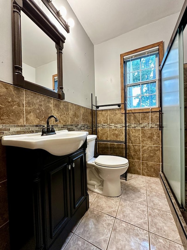 39 Leonard St, Elgin, IL 60123 - bathroom featuring tile walls, vanity, a stall shower, wainscoting, and tile patterned floors