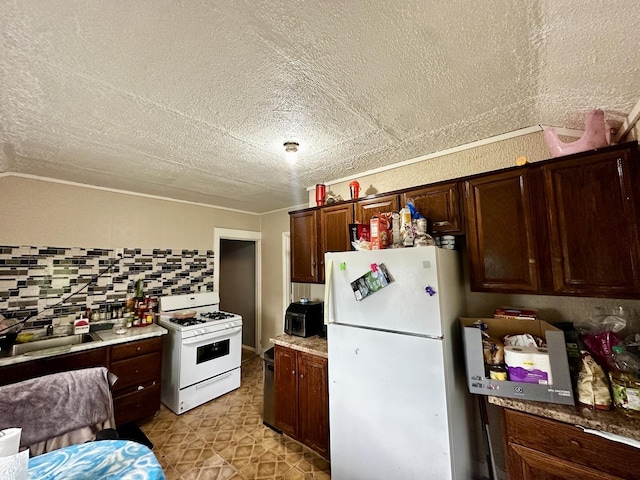 39 Leonard St, Elgin, IL 60123 - kitchen featuring white appliances, a textured ceiling, light countertops, tasteful backsplash, and dark brown cabinets