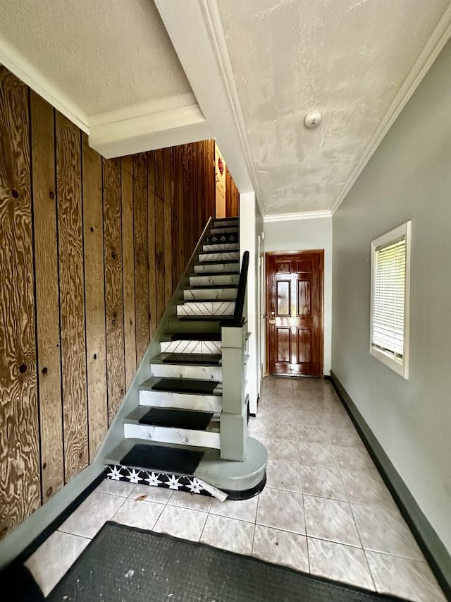39 Leonard St, Elgin, IL 60123 - stairs with wooden walls, tile patterned floors, ornamental molding, and a textured ceiling