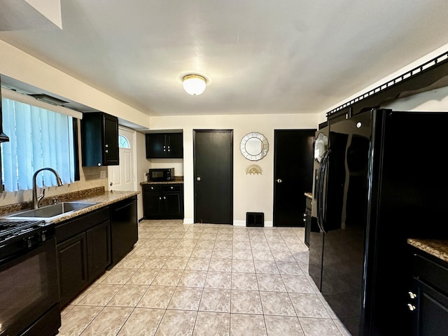 39 Leonard St, Elgin, IL 60123 - kitchen with black appliances, dark cabinets, and light tile patterned floors