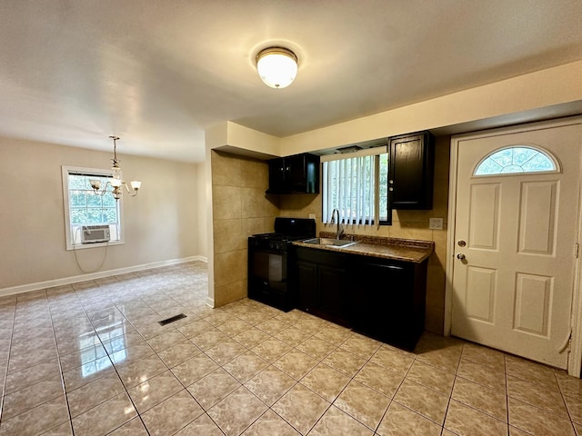 39 Leonard St, Elgin, IL 60123 - kitchen with black appliances, plenty of natural light, a chandelier, and light tile patterned floors