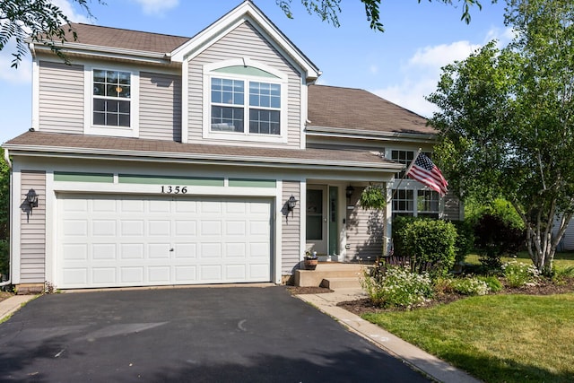 1356 Geneva Ln, Cary, IL 60013 - traditional-style home with asphalt driveway, a garage, and a front lawn