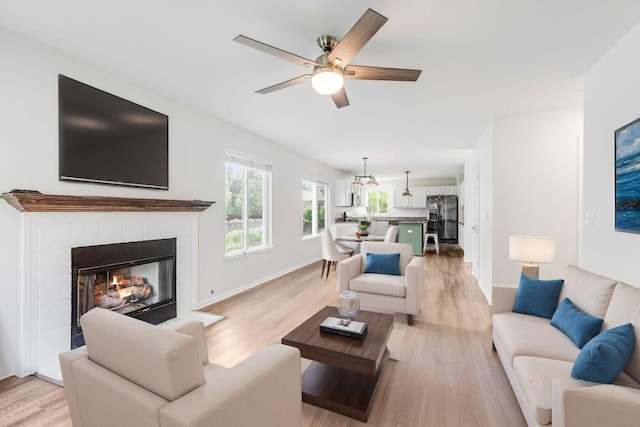 1356 Geneva Ln, Cary, IL 60013 - living area featuring a ceiling fan, light wood finished floors, and a tile fireplace