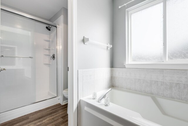 1356 Geneva Ln, Cary, IL 60013 - bathroom with healthy amount of natural light, a garden tub, a shower stall, and wood finished floors