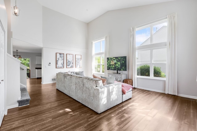1356 Geneva Ln, Cary, IL 60013 - living area featuring high vaulted ceiling, dark wood finished floors, healthy amount of natural light, and stairway