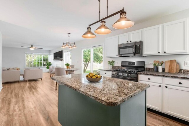 1356 Geneva Ln, Cary, IL 60013 - kitchen with stainless steel appliances, a center island, white cabinets, and dark stone countertops