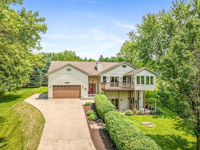 1375 Coven Cir, Davis, IL 61019 - view of front of house with a front lawn, concrete driveway, and a garage