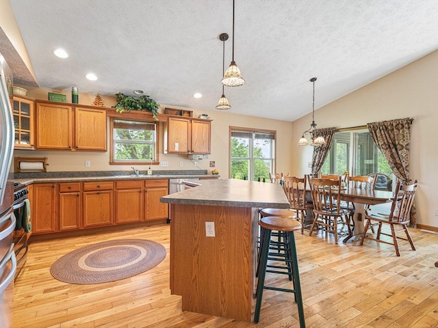 1375 Coven Cir, Davis, IL 61019 - kitchen with a textured ceiling, light wood finished floors, a center island, lofted ceiling, and recessed lighting