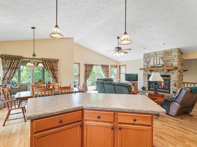 1375 Coven Cir, Davis, IL 61019 - kitchen featuring light wood-style flooring, a ceiling fan, a textured ceiling, lofted ceiling, and decorative light fixtures