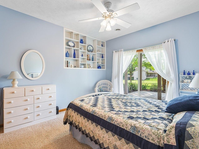 1375 Coven Cir, Davis, IL 61019 - carpeted bedroom featuring access to exterior, a textured ceiling, and ceiling fan