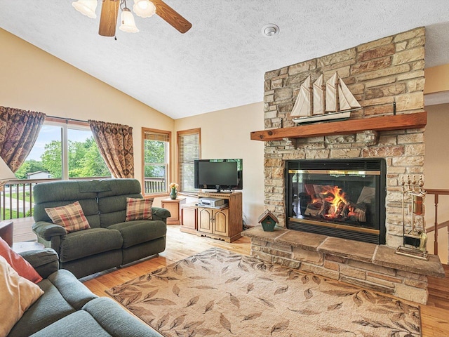 1375 Coven Cir, Davis, IL 61019 - living area with wood finished floors, a textured ceiling, a ceiling fan, lofted ceiling, and a fireplace