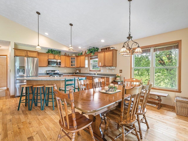 1375 Coven Cir, Davis, IL 61019 - dining space featuring light wood finished floors, vaulted ceiling, recessed lighting, and a chandelier