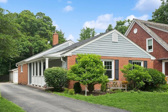 72 Atteridge Rd, Lake Forest, IL 60045 - bungalow-style house with brick siding, a chimney, a garage, and covered porch