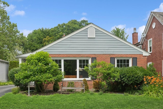 72 Atteridge Rd, Lake Forest, IL 60045 - rear view of house with a yard, brick siding, and a chimney
