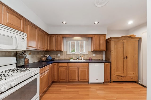72 Atteridge Rd, Lake Forest, IL 60045 - kitchen featuring white appliances, light wood-type flooring, dark countertops, backsplash, and brown cabinets