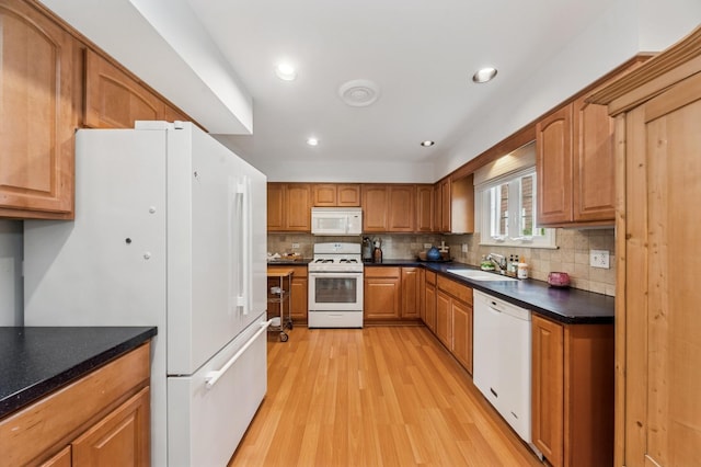 72 Atteridge Rd, Lake Forest, IL 60045 - kitchen with white appliances, light wood-style floors, decorative backsplash, brown cabinetry, and dark countertops