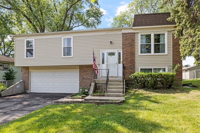 125 E Robinhood Way, Bolingbrook, IL 60440 - bi-level home featuring a garage, driveway, a front yard, and brick siding