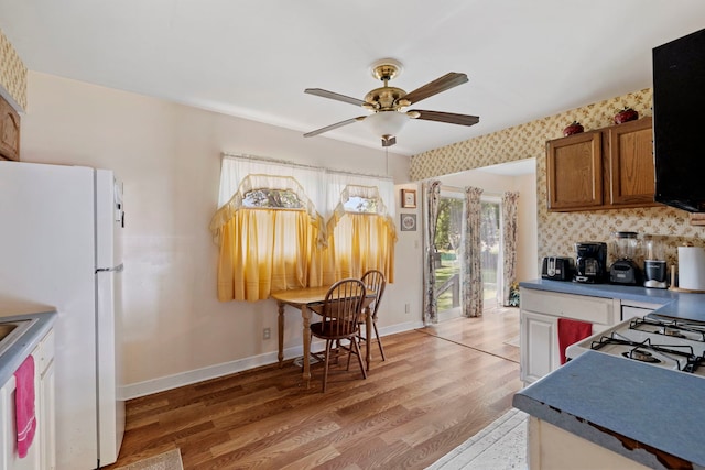 125 E Robinhood Way, Bolingbrook, IL 60440 - kitchen featuring freestanding refrigerator, a ceiling fan, light wood-style flooring, brown cabinetry, and dark countertops