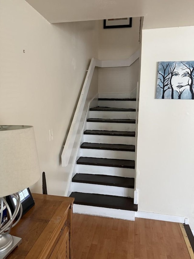 stairway with wood finished floors