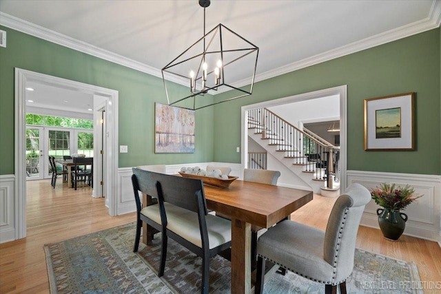 25660 N Countryside Dr, Lake Barrington, IL 60010 - dining area with crown molding, stairway, light wood-style floors, a decorative wall, and a chandelier