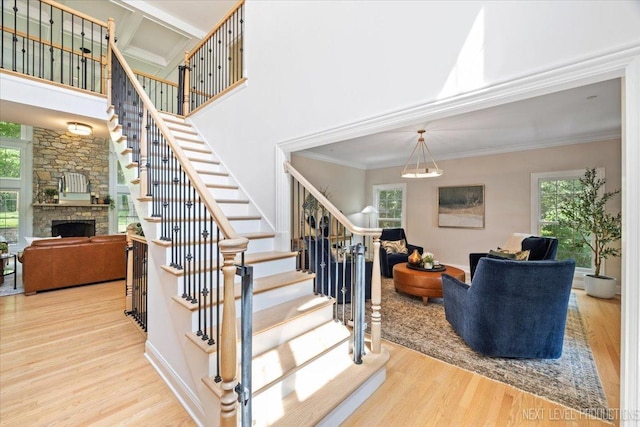 25660 N Countryside Dr, Lake Barrington, IL 60010 - stairs featuring wood finished floors, a fireplace, crown molding, and a high ceiling