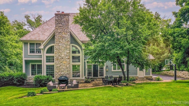 25660 N Countryside Dr, Lake Barrington, IL 60010 - back of house featuring a chimney, a yard, stone siding, and a patio