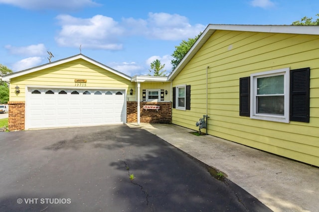 19705 Glennell Ave, Mokena, IL 60448 - view of home's exterior featuring asphalt driveway, brick siding, and an attached garage