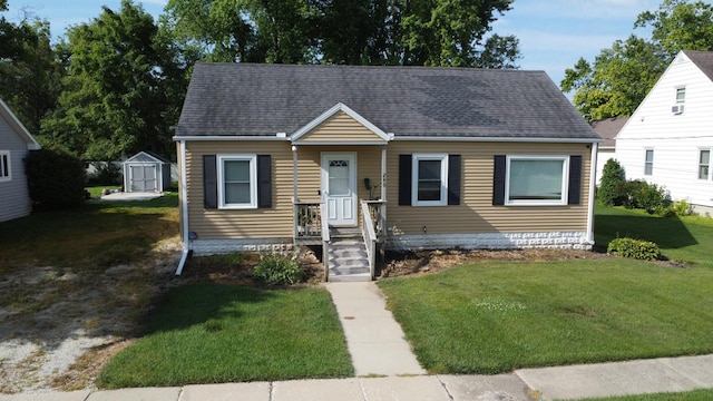 240 E 3rd Ave, Clifton, IL 60927 - view of front of property with a front lawn, a shingled roof, and a shed