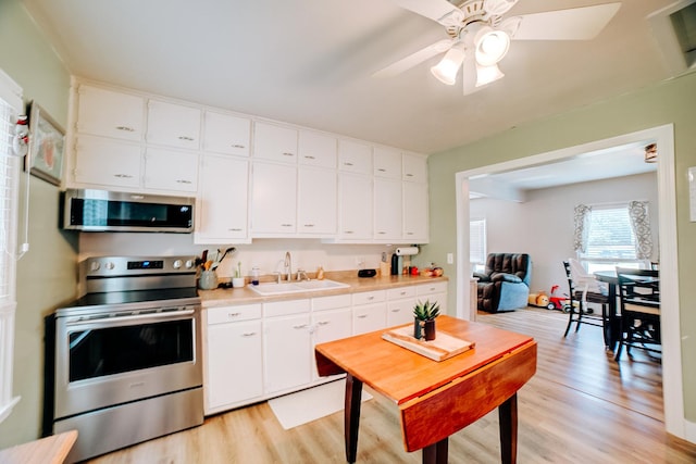 240 E 3rd Ave, Clifton, IL 60927 - kitchen featuring stainless steel appliances, light wood finished floors, light countertops, and ceiling fan