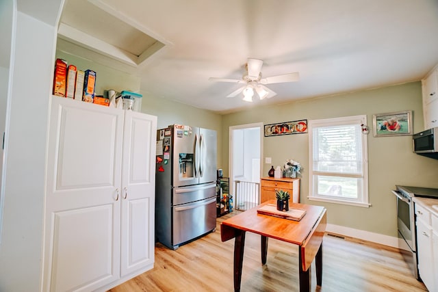 240 E 3rd Ave, Clifton, IL 60927 - kitchen with stainless steel appliances, light wood finished floors, a ceiling fan, and white cabinetry