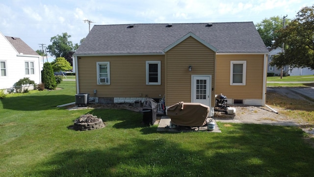 240 E 3rd Ave, Clifton, IL 60927 - rear view of house with an outdoor fire pit, a yard, and a shingled roof