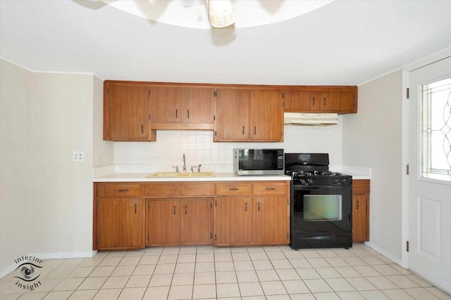 7235 174th Pl, Tinley Park, IL 60477 - kitchen featuring black gas stove, stainless steel microwave, under cabinet range hood, backsplash, and light countertops