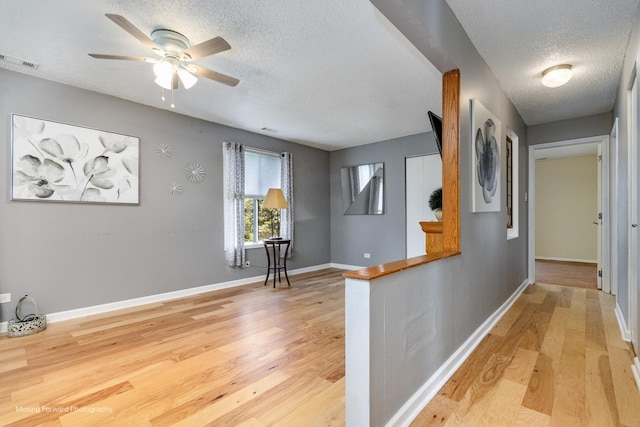 11207 Cottonwood Dr Unit 21C, Palos Hills, IL 60465 - hall featuring a textured ceiling and light wood-style floors