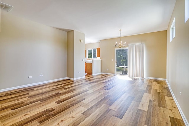 2559 Lincoln Park Ct Unit 2559, Crest Hill, IL 60403 - unfurnished living room featuring a chandelier and light wood finished floors