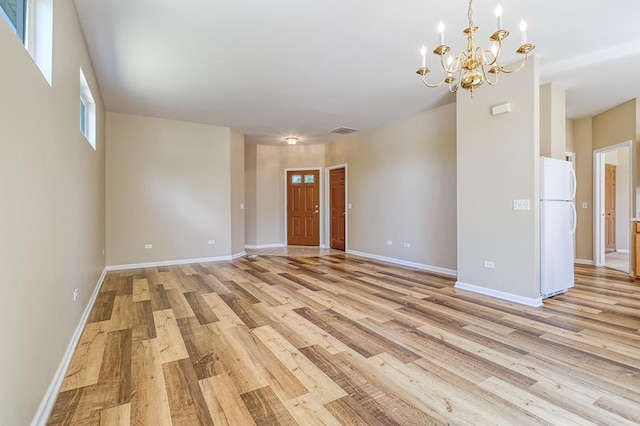 2559 Lincoln Park Ct Unit 2559, Crest Hill, IL 60403 - unfurnished living room featuring light wood finished floors and a chandelier