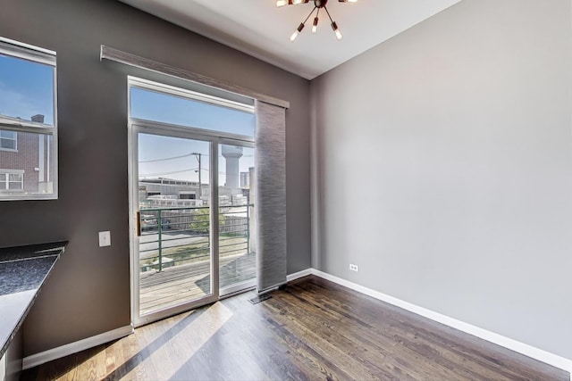 7501 Brown Ave Unit 3C, Forest Park, IL 60130 - unfurnished room featuring wood finished floors, healthy amount of natural light, and a chandelier