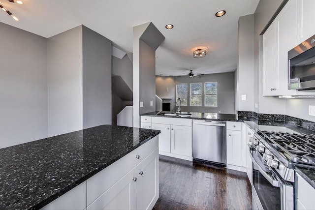 7501 Brown Ave Unit 3C, Forest Park, IL 60130 - kitchen featuring appliances with stainless steel finishes, a ceiling fan, dark stone counters, dark wood finished floors, and white cabinetry