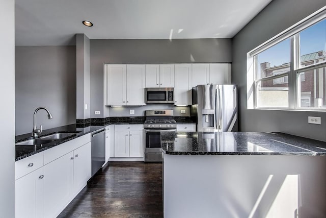 7501 Brown Ave Unit 3C, Forest Park, IL 60130 - kitchen with appliances with stainless steel finishes, a peninsula, dark stone countertops, white cabinetry, and recessed lighting