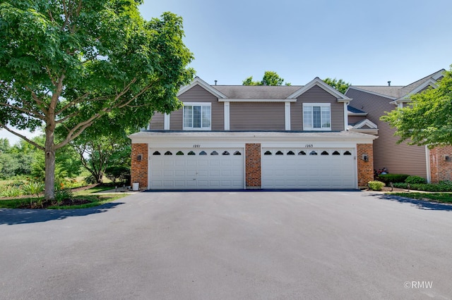 1261 River Ash Ct, Bartlett, IL 60103 - view of front of house featuring asphalt driveway, brick siding, and an attached garage