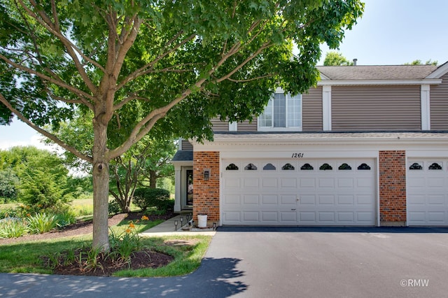 1261 River Ash Ct, Bartlett, IL 60103 - view of front of property featuring brick siding, asphalt driveway, roof with shingles, and a garage