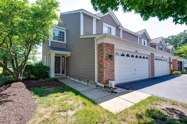 1261 River Ash Ct, Bartlett, IL 60103 - traditional-style house featuring a garage, brick siding, and driveway
