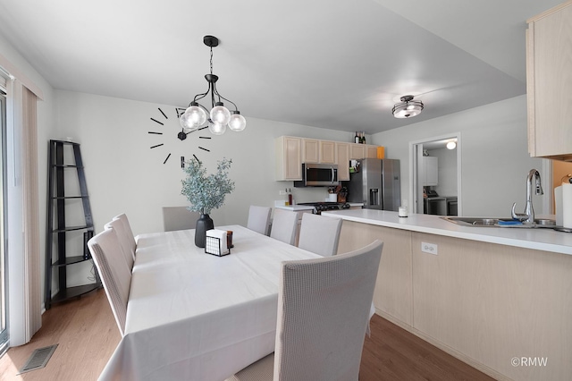 1261 River Ash Ct, Bartlett, IL 60103 - dining room with light wood-type flooring and a chandelier