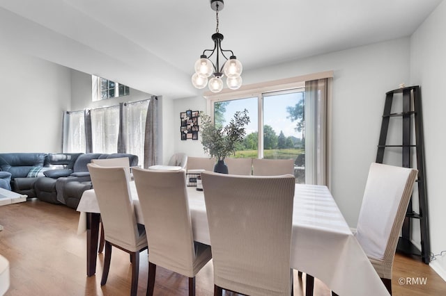 1261 River Ash Ct, Bartlett, IL 60103 - dining area with a chandelier and light wood-style floors