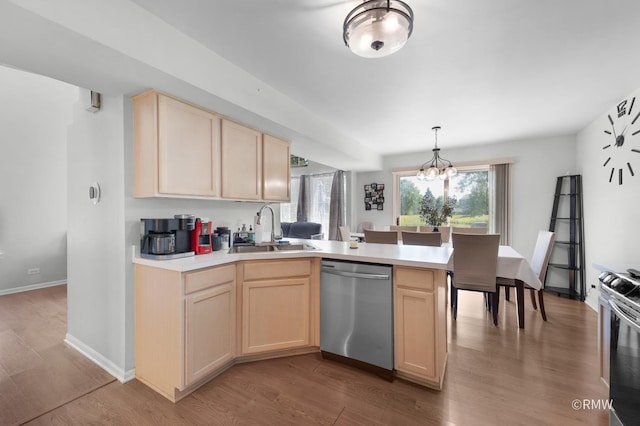 1261 River Ash Ct, Bartlett, IL 60103 - kitchen with appliances with stainless steel finishes, light brown cabinets, a peninsula, and light countertops