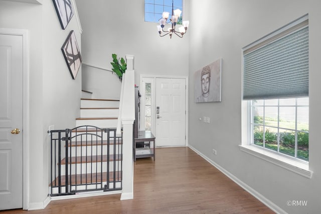 1261 River Ash Ct, Bartlett, IL 60103 - foyer with a chandelier, wood finished floors, stairway, and a high ceiling