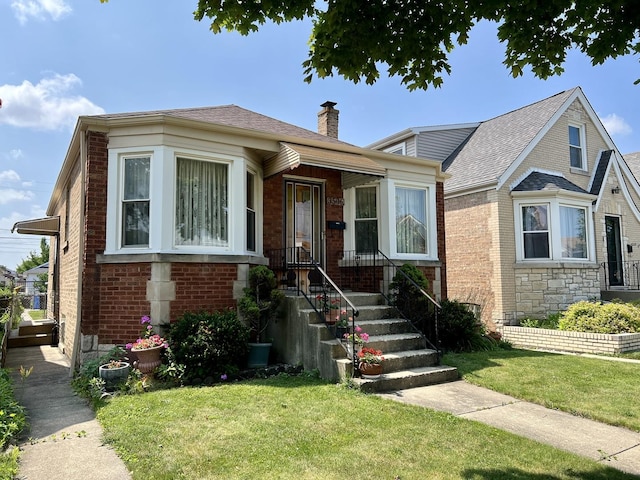 3506 N Rutherford Ave, Chicago, IL 60634 - view of front of property featuring a chimney, a front lawn, and brick siding