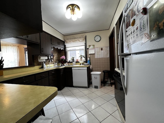 3506 N Rutherford Ave, Chicago, IL 60634 - kitchen with white appliances, light tile patterned flooring, light countertops, and tile walls