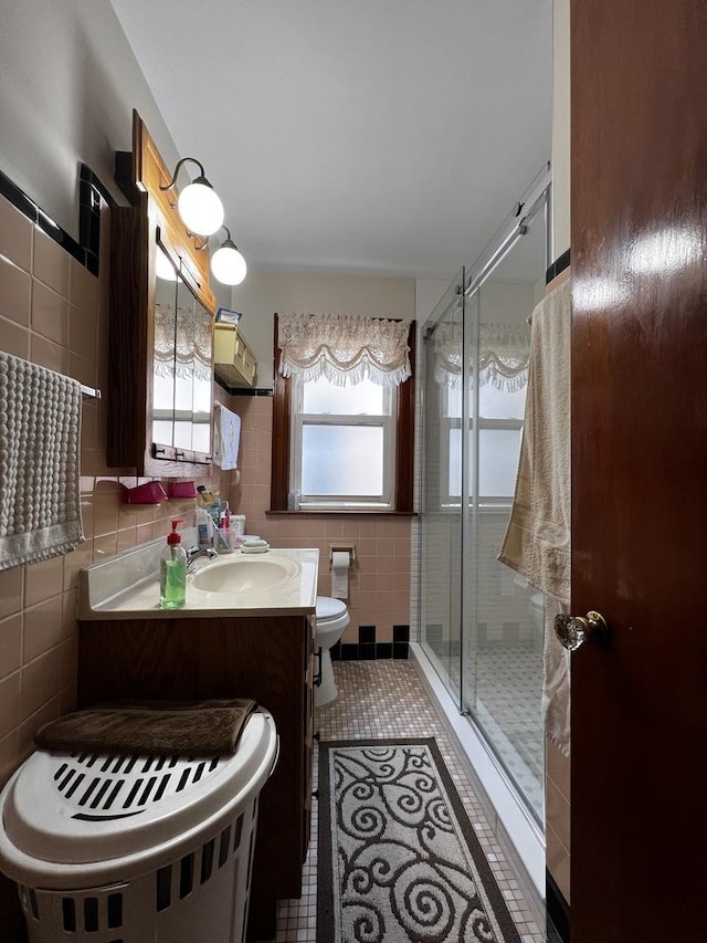 3506 N Rutherford Ave, Chicago, IL 60634 - full bathroom with tile walls, vanity, a stall shower, and tile patterned flooring