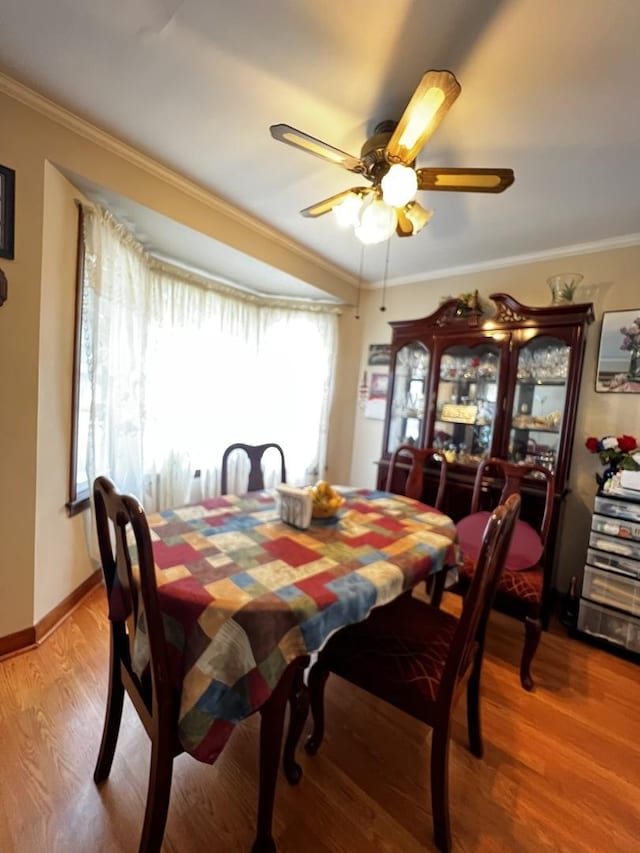3506 N Rutherford Ave, Chicago, IL 60634 - dining room with crown molding, a ceiling fan, and wood finished floors